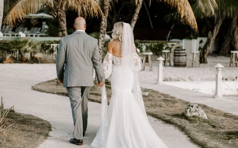 Backside view of a newly wedding couple walking around the venue.