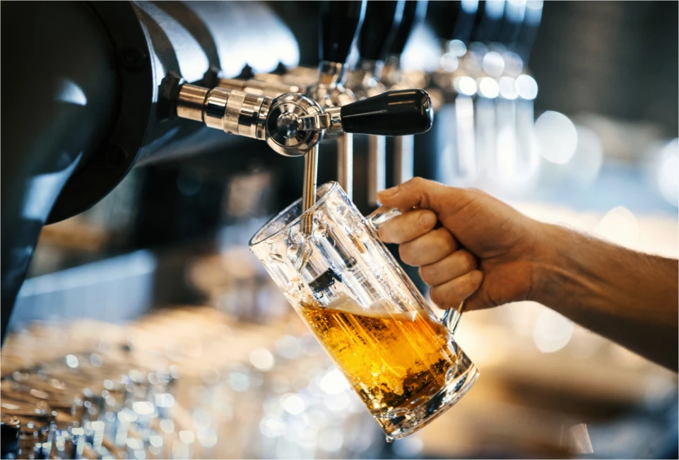 a close-up of a person pouring a liquid into a glass