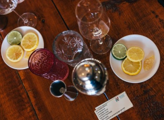 a table with glasses and plates of lemons
