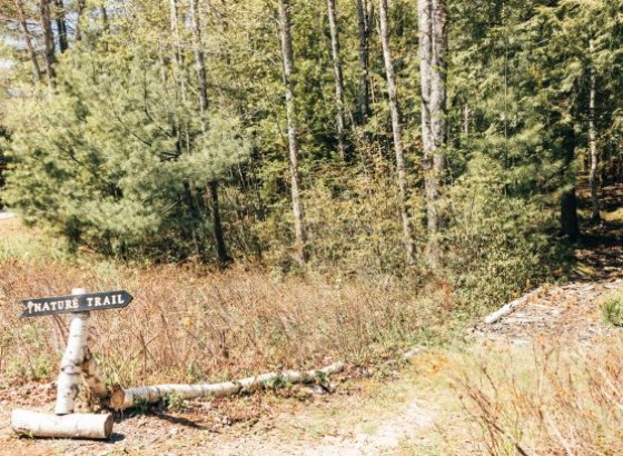 a sign on a trail in the woods
