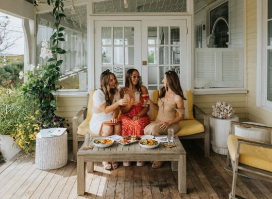 a group of women sitting on a bench