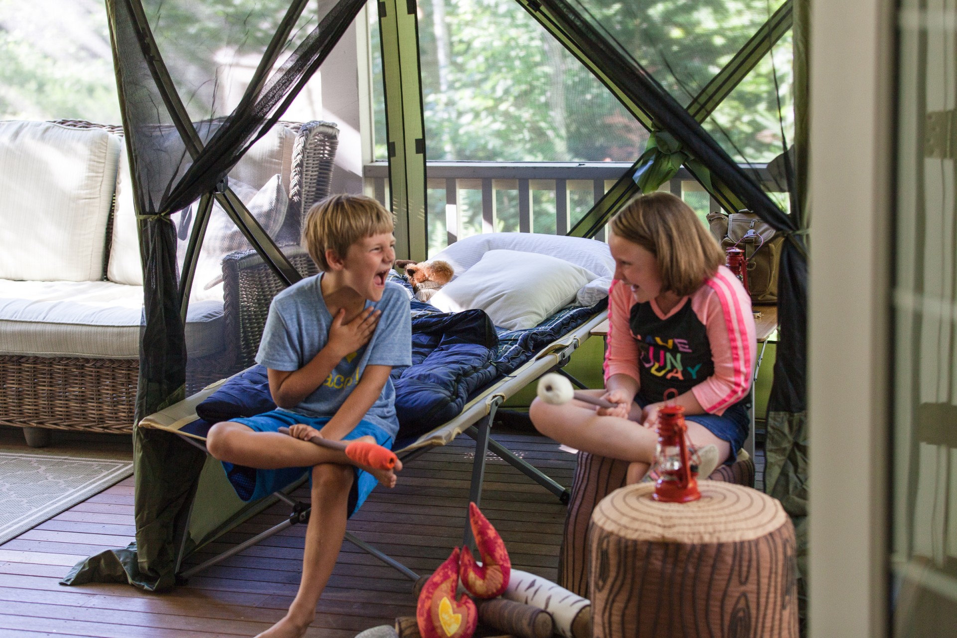 a boy and girl sitting on a deck