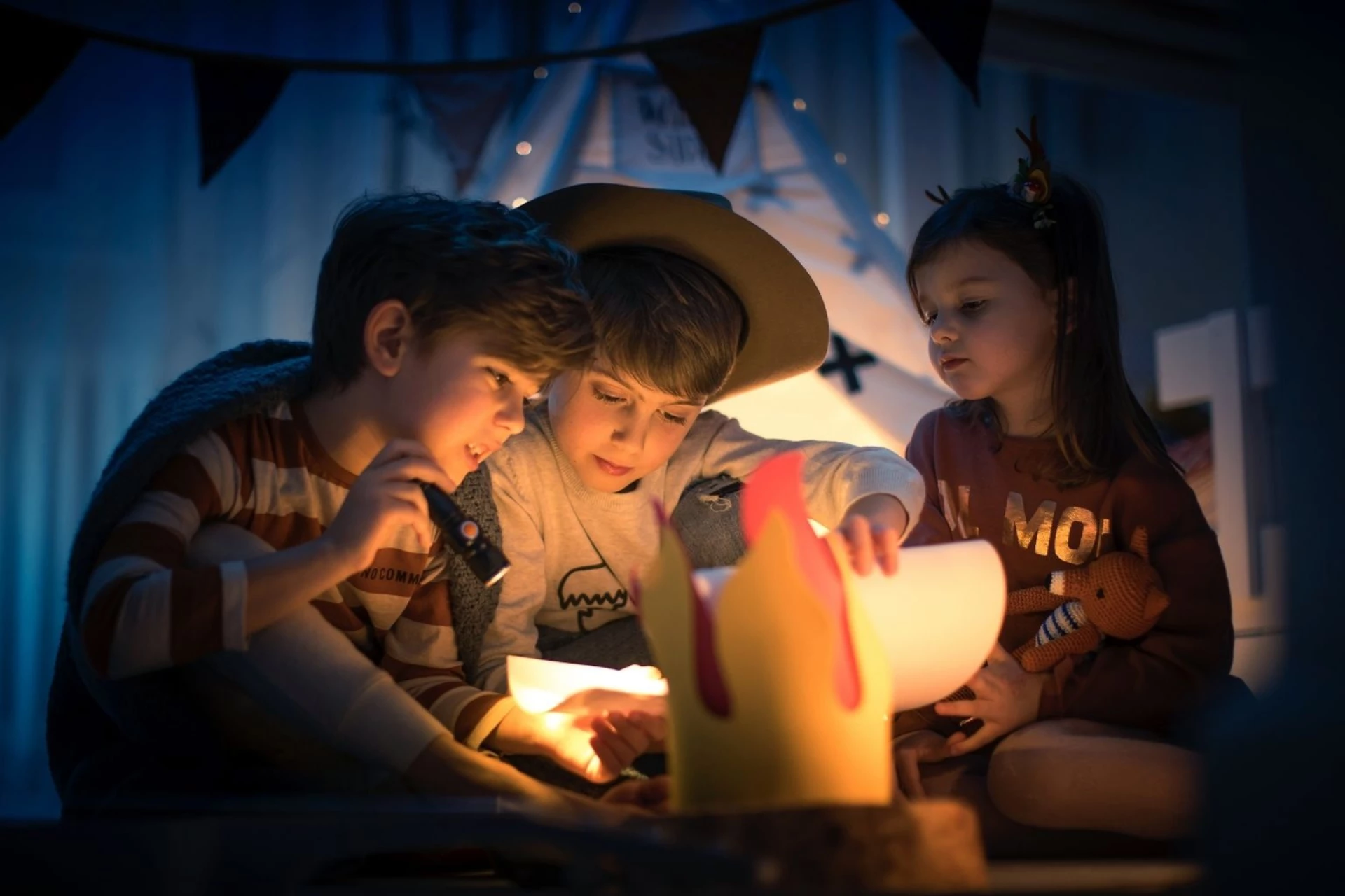 a group of kids looking at a paper lantern