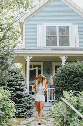 woman walking out from her cottage