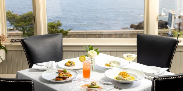 a table with plates of food and drinks on it