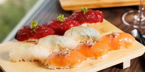a plate of sushi on a wood surface