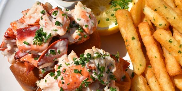 a plate of food with a lemon wedge and a sauce