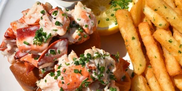 a plate of food with a lemon wedge and a sauce