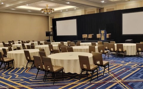meeting room with rounded tables and a big stage13