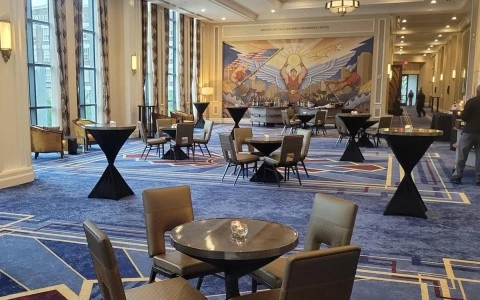 meeting room with multiple tables and a big painting behind2