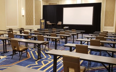meeting room with a stage and some desks 9