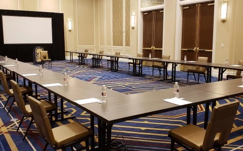 conference room with two big entrances and a screen in the middle14