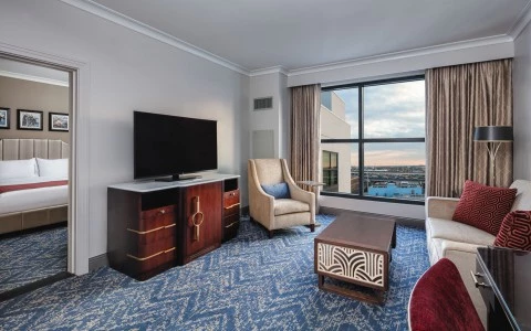 bedroom with a sofa and a tv with a city view 25