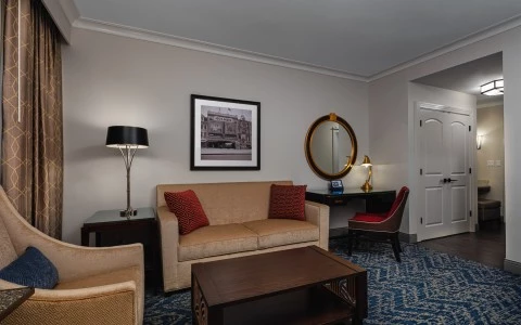 bedroom with a living room with a sofa and a chair and a desk 22