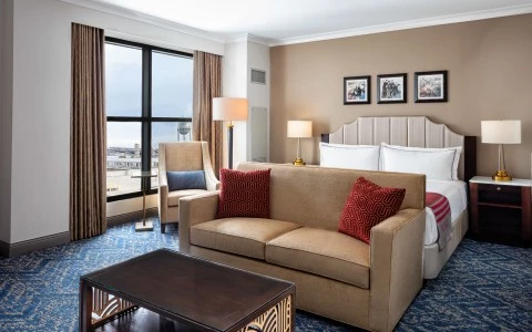 bedroom with a double bed two side lamps and a yellow sofa18