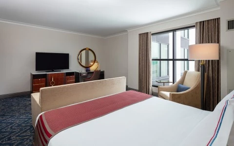 bedroom with a double bed, a sofa and a tv 33