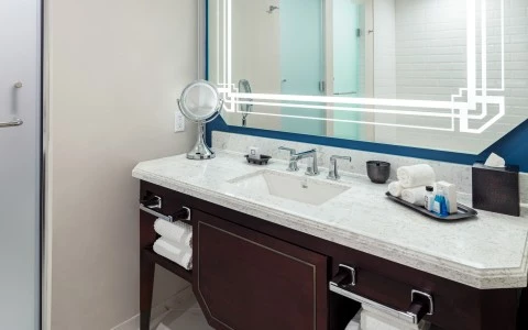 side view of a sink with a wall mirror and some towels 31