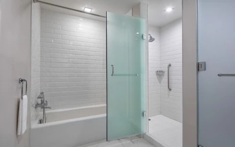 side view of a white bathtub with crystal door 30