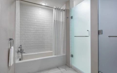 side view of a white bathtub with curtains 29