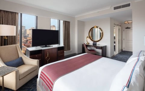 bedroom with a double bed and side desk and a tv 27