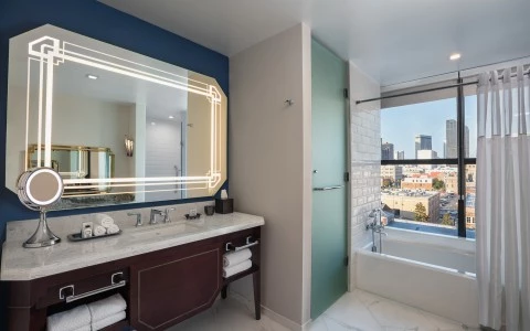 bathroom with a bathtub and side door with amazing city view 26