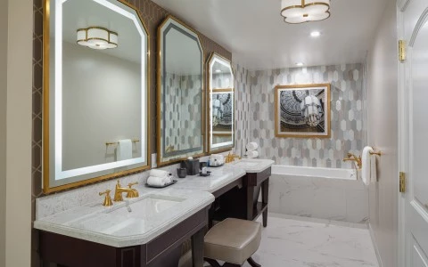 bathroom with a bathtub and two sinks 3