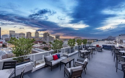 a rooftop patio with chairs and tables and trees0