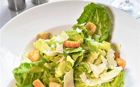 Caesar salad topped with croutons and shaved parmesan 19