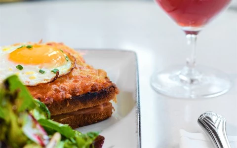 Croque madame topped with a sunny side egg with a side salad11