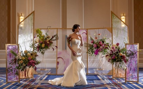 woman with a wedding dress with a crystal wall behind and some flowers11