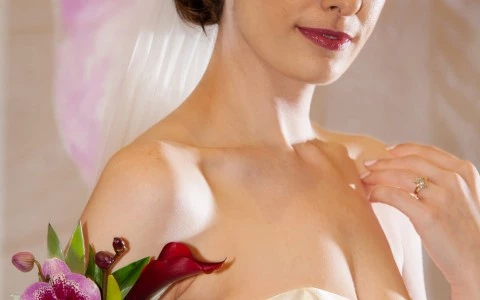 woman with a wedding dress showing her ring and some flowers 6