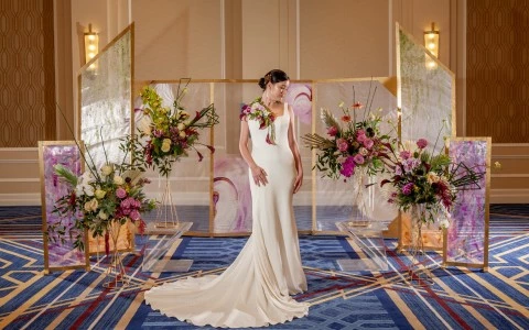 woman with a wedding dress with a crystal wall behind and some flowers47