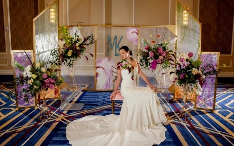 woman with a wedding dress with a crystal wall behind and some flowers9