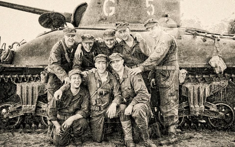 a group of men posing for a photo in front of a tank