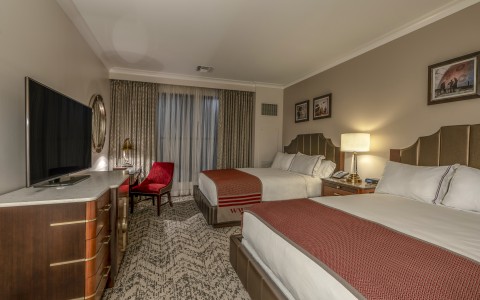 a room with two beds and a tv