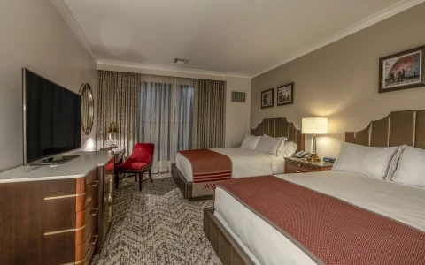 a room with two beds and a tv