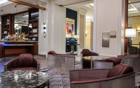 two rounded tables with chairs and Kilroy's bar at the background 3