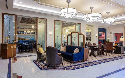interior hall with a blue sofa and meeting table also with a USA flag on the wall 2