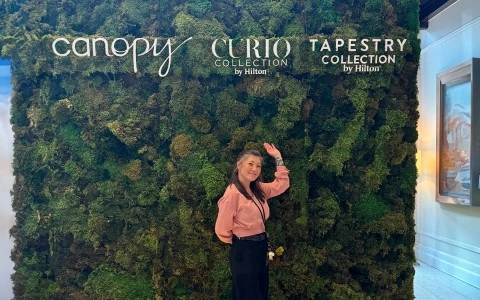 a woman standing in front of a wall of plants9
