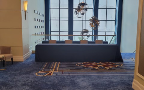 a table with chairs in a room with large windows