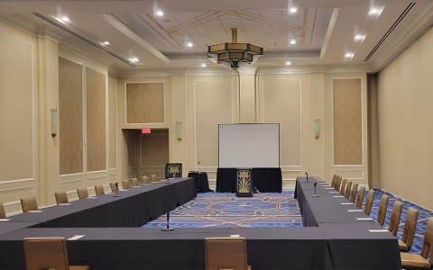 a room with a large table and chairs