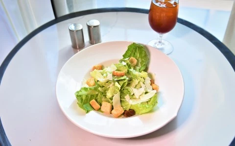 a plate of salad and a glass of liquid23