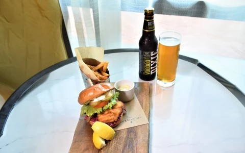 a burger and fries on a wooden board25
