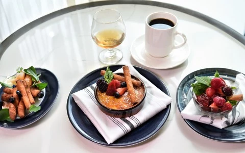 a bowl of dessert with fruit and a cup of coffee27