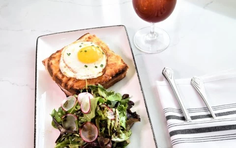 a plate of food and a glass of wine29