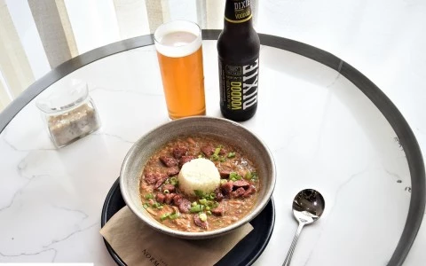 a bowl of food and a beer on a table37