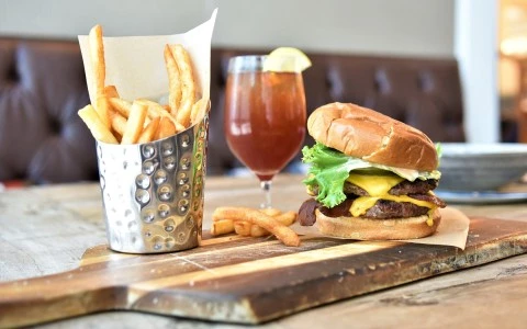 a burger and fries on a wooden board39