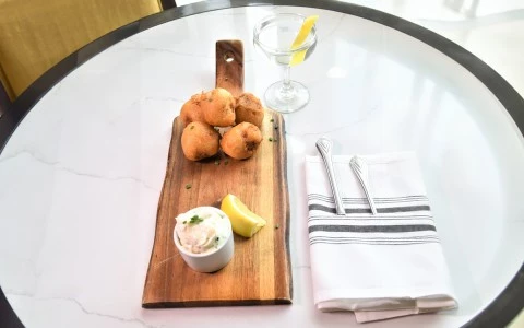a wooden tray with food on it and a glass of water43