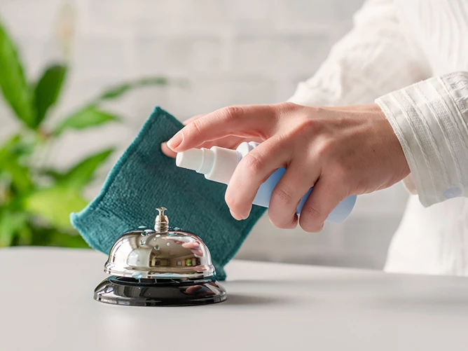 woman's hand touching a service bell