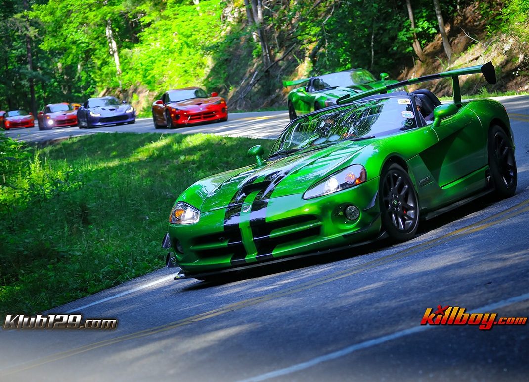 a green sports car on a road